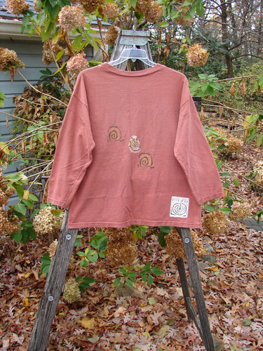 1991 Long Sleeved Tee Sun Guy Brick OSFA displayed on a swinger, showcasing its vintage appeal with unique design elements, fitting the BlueFishFinder's ethos of creative expression through clothing.