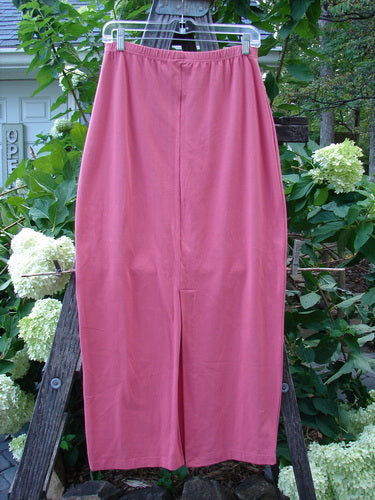 1996 NWT Cotton Lycra Column Skirt Unpainted Oriole Size 2, displayed on a clothesline, showcasing its slimming pegged hemline and full flattened elastic waistline.