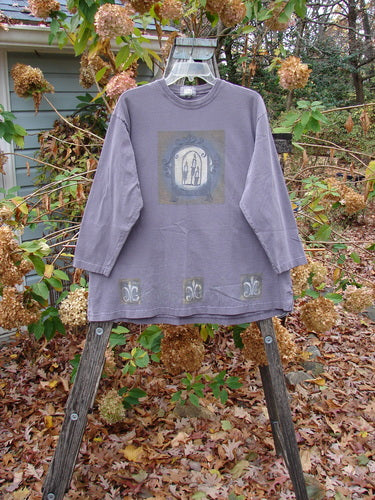 1999 Long Sleeved Tee Candle Blackberry Size 1 displayed on a swinger, highlighting its vintage Blue Fish Clothing style, perfect for autumn wear, capturing the essence of outdoor creativity and individuality.