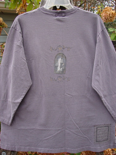 1999 Long Sleeved Tee Candle Blackberry Size 1 features a drawing of a window with candles on a grey shirt, embodying the vintage and creative style of Blue Fish Clothing.