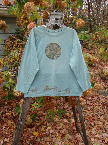 1993 Long Sleeved Tee Medallion Field Ocean OSFA displayed on a hanger outdoors, emphasizing its vintage Blue Fish Clothing style suitable for creative self-expression.