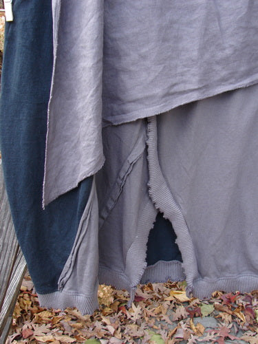 Barclay Mixed Media Swatch Skirt, a close-up of textured clothing with alternating layered upper, sectional panels, and full elastic waistline.