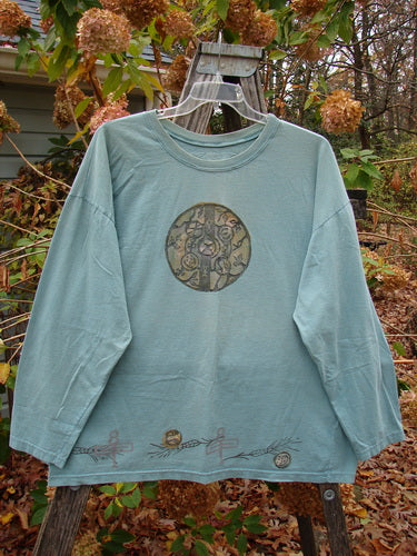 1993 Long Sleeved Tee Medallian Field Ocean OSFA displayed on a clothes rack, reflecting the unique vintage style of Bluefishfinder.com, known for its expressive and creative women's clothing.