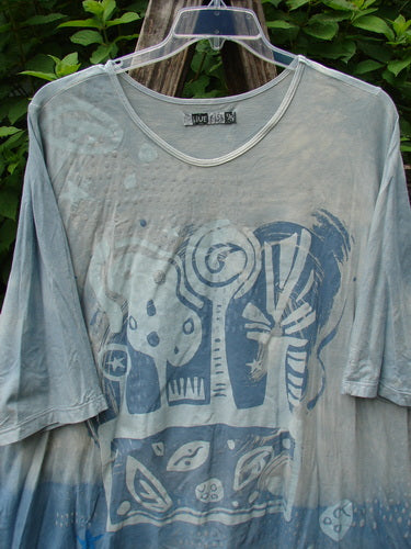 Barclay Tournesol Tunic Flower Power Mottled Day Sky OSFA: Close-up of a loose-fitting, mid-length dress with three-quarter sleeves, drop shoulders, rounded neckline, and varying hemline longer in the back.