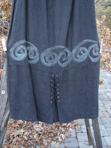 2000 Pages Market Duo Celtic Black Size 2: A black dress with a design on it. Super laced front and sleeve, varying hemline, and large front pockets with Celtic paint and bottom fringe.