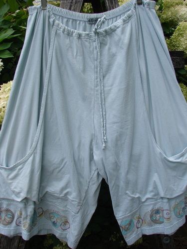 Barclay Bushel Short Planetarium in clear blue, size 2, with a loose draped silhouette, gathered elastic waistband, and wide cropped legs. The lightweight fabric has a soft matte finish, while the hem is finished with a subtle planetarium motif in muted tones.