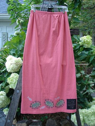 1996 Straight Skirt River Fish Oriole Size 0 hanging on a clothesline, showcasing its full elastic waistband and slightly A-line shape, indicative of Blue Fish Clothing's vintage, organic cotton collection.