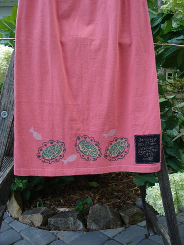 1996 Straight Skirt River Fish Oriole Size 0, displayed hanging on a clothesline, showcasing its full elastic waistband and slight A-line shape, made from organic cotton with a river fish theme.