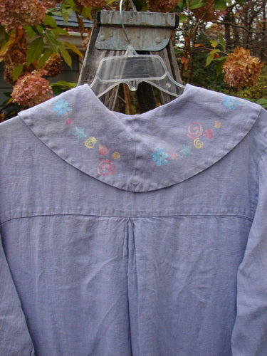 1999 Breeze Jacket Flower Heart Iris OSFA, showcasing a close-up of its sailor-painted collar and oversized drop pockets, with sweet heart and flower-themed paint, hanging from a metal hook.