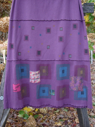 Barclay Patched Fold Over Ruffle Panel Skirt with squares and squares on it, made from organic cotton thermal. Features include a fold over waist line panel, exterior horizontal stitchery, sweet tiny patches along the hem panel, and coordinating continuous stripes. Size 2, 40" full length.
