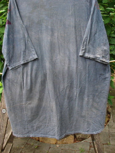 Barclay Tournesol Tunic Gull Flock Mottled Night Sky OSFA displayed on a clothesline, featuring a tunic length, drop shoulders, three-quarter sleeves, rounded neckline, and asymmetric hemline, embodying vintage Blue Fish Clothing style.