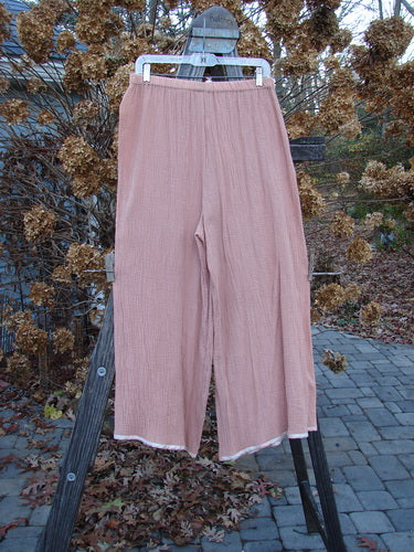 1998 Gauze Shell Layering Duo Tiny Floral Blush Size 2: A pair of pants on a rack, close-up of pants, grey object, and wooden post.
