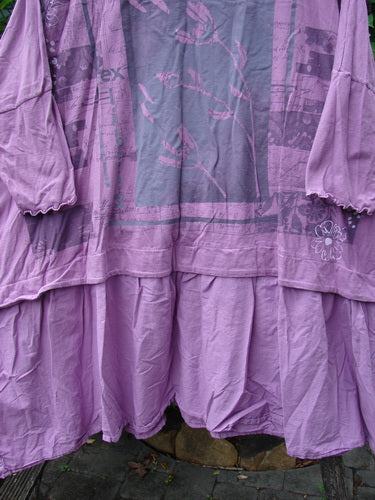 Barclay Batiste Banded Flounce Esperanza Tunic Sprig Crocus OSFA features a rounded neckline, dolman sleeves with lettuce edges, and a sprig theme, highlighting its unique boxy shape and varying hemline.