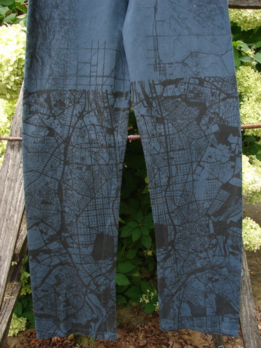 Barclay Cotton Lycra Straight Pant City Plan Lux Silhouette Size 0 in blue cotton-lycra, with a straight-leg cut and dark city-map print. The pants hang front-facing against a rustic outdoor backdrop, where the textured fabric and muted slate tones stand out.