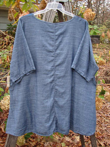 Barclay Woven Short Sleeved Pullover Tunic Mum Cross Dye Navy Size 1 displayed on a clothesline, showcasing its lightweight cotton fabric and short sleeves. Ideal for expressing individuality through vintage-inspired fashion.