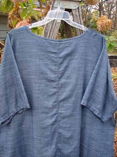 Barclay Woven Short Sleeved Pullover Tunic Mum Cross Dye Navy Size 1 hanging on a clothes rack, showcasing its lightweight cotton fabric and short sleeves, reflecting Bluefishfinder.com's vintage style.