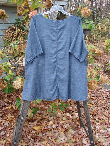 Barclay Woven Short Sleeved Pullover Tunic Mum Cross Dye Navy Size 1 displayed on a clothes rack, showcasing its lightweight cotton fabric and short sleeves, perfect for expressing individuality through vintage style.