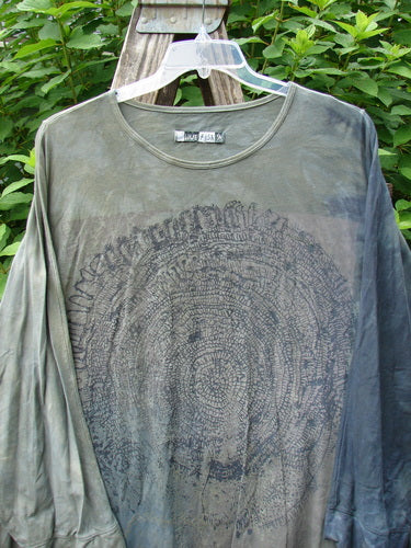 Barclay Art Tee Tree Life Ring in Mottled Army Black displayed on a hanger, showcasing its tunic length, drop shoulders, loose three-quarter sleeves, rounded neckline, and varying hemline.