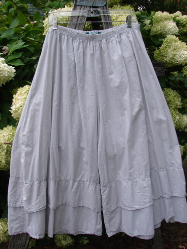 Barclay Batiste Cotton Wide Leg Carassai Pant in unpainted stone, size 2, shown as airy cotton wide-leg pants with a gathered elastic waist and tiered hem. The soft matte fabric hangs in a loose, voluminous silhouette.