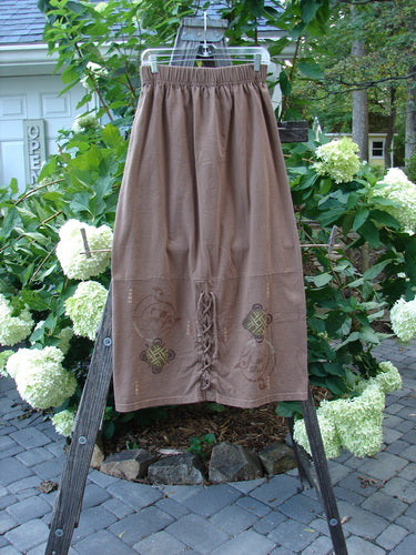 1997 Escapade Skirt Celtic Turn Mandorla Size 1 displayed on a wooden stand, featuring a sectional bottom panel with long lacings and a full 2-inch elastic waistline.