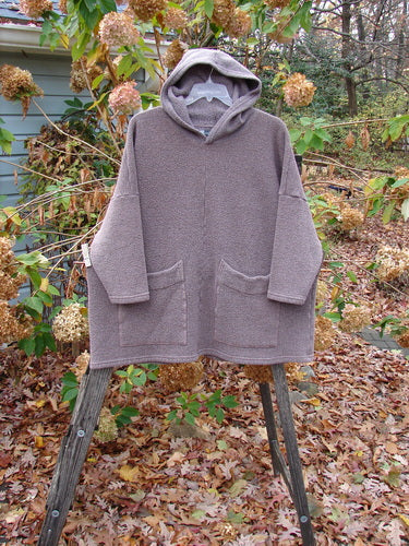 Barclay Fleece Hooded Square Pocket Pullover Unpainted Variegated Stone OSFA displayed on a wooden stand, showcasing its heavy-weight fabric and distinct square pocket design, embodying Bluefishfinder.com's vintage-inspired clothing ethos.