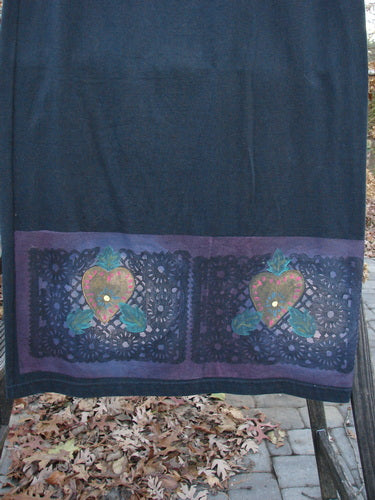 1999 Vented Straight Duo Heart Black Size 1: A blue towel with a heart design, close-up of cloth, and a pile of brown leaves.