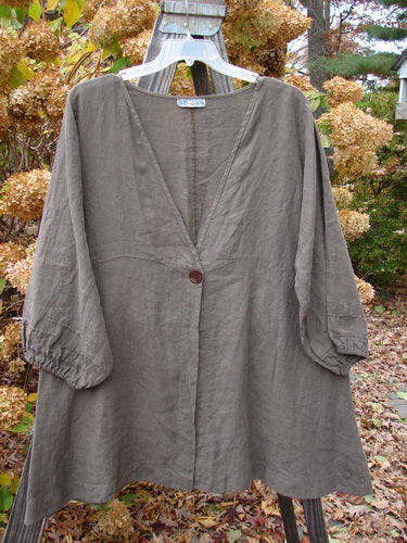 Barclay Linen Deep V Single Button Cardigan on a swinger, close-up of a metal object.