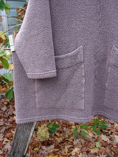 Barclay Fleece Hooded Square Pocket Pullover Unpainted Variegated Stone OSFA displayed on a wooden post, showcasing its heavy-weight organic cotton recycled poly fabric, highlighting BlueFishFinder's unique, expressive vintage style.