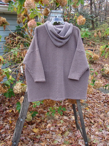 Barclay Fleece Hooded Square Pocket Pullover Unpainted Variegated Stone OSFA displayed on a wooden stand, showcasing its cozy, heavyweight organic cotton blend and unique square pocket design, epitomizing vintage Blue Fish Clothing style.