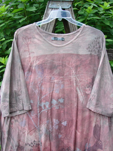 Barclay Tournesol Tunic Bunny Field Mottled Mauve OSFA displayed on a hanger, showcasing its tunic length, drop shoulders, loose three-quarter sleeves, rounded neckline, and varying hemline with bunny-themed paint.