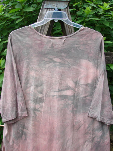 Barclay Tournesol Tunic Bunny Field Mottled Mauve OSFA displayed on a clear plastic hanger, showcasing its longer tunic length, drop shoulders, loose three-quarter sleeves, and unique hemline.