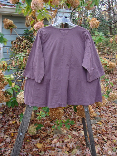 Barclay Three Quarter Sleeved Cafe Top Parrot Burgundy Size 2 displayed on an outdoor swing, showcasing its medium weight and unique design, embodying Bluefishfinder.com's commitment to vintage Blue Fish Clothing style and individuality.