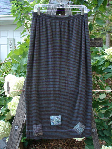 2000 Patched Rayon Lycra Rib Linear Skirt Burgundy Stripe Altered Size 1 displayed on a wooden ladder, highlighting its flared shape and elastic waistband with visible hem stitchery.