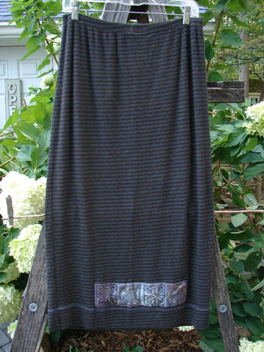 2000 Patched Rayon Lycra Rib Linear Skirt in Burgundy Stripe, displayed hanging outdoors, highlighting its slightly flared lower shape and superior bouncy movement, from the Holiday Collection of 2000.