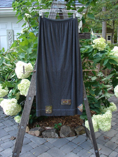 2000 Patched Rayon Lycra Rib Linear Skirt in Charcoal Heather, size 1, displayed on a clothes rack, showcasing its full elastic waistband, slightly flared shape, and exterior horizontal hem stitchery.