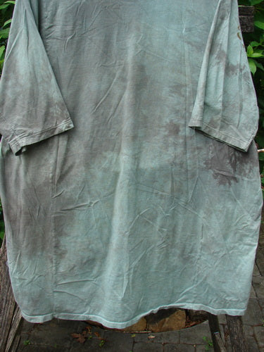 Barclay Tournesol Tunic Spotted Cat Mottled Grass Field OSFA, showcasing a loose fit with drop shoulders, three-quarter sleeves, and a rounded neckline. Features unique side garden and tiny village theme paint.