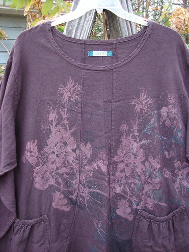 Barclay Woven Figure 8 Pocket Tunic Dress Bouquet Deep Wine Size 2 features a floral pattern on a purple background, highlighting its long sleeves and casual, vintage-inspired design from Blue Fish Clothing.