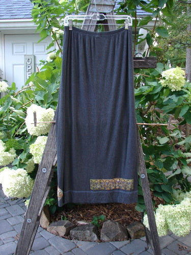 2000 Patched Rayon Lycra Rib Linear Skirt Charcoal Heather Size 1 displayed draped over a wooden ladder, showcasing its full elastic waistband and slightly flared lower shape.