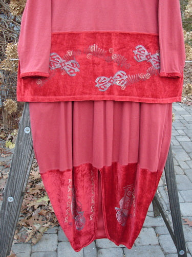 1996 Velvet Arrowhead Sofia Duo Pomegranate Size 1: A red and silver dress on a ladder. Stretch velvet and cotton jersey. Accented V neckline, cuffs, and drop waistline. Dropped shoulders, longer shape. Bell-shaped skirt with accent hem and rear kick vent. Elastic waistline, deeply pocketed.