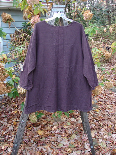 Barclay Woven Figure 8 Pocket Tunic Dress Bouquet Deep Wine Size 2 displayed on a clothes rack, exemplifying vintage Blue Fish Clothing's unique style with a heavy weight long-sleeved design.