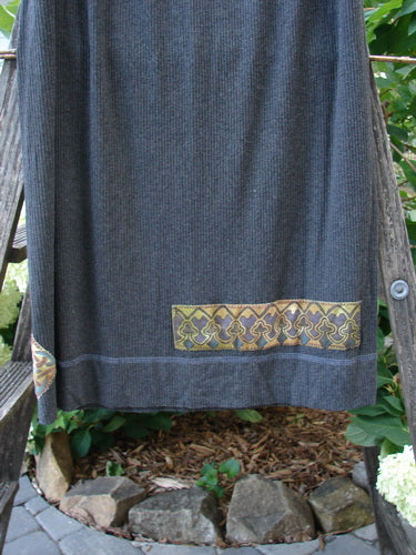 2000 Patched Rayon Lycra Rib Linear Skirt in Charcoal Heather, Size 1, displayed on a ladder highlighting its full elastic waistband and exterior horizontal lower hem stitchery.