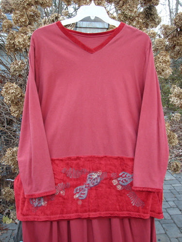 1996 Velvet Arrowhead Sofia Duo Pomegranate Size 1: A red shirt with a red patch on it and a long sleeved shirt with a red trim.