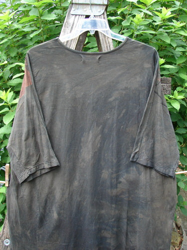 Barclay Tournesol Tunic Daisy Crane Metallic Bark OSFA displayed on a clothes rack, showcasing its mid-length design, drop shoulders, loose three-quarter sleeves, and rounded neckline, embodying BlueFishFinder's vintage and creative style.