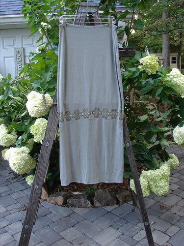 2000 Rayon Lycra Narrow Skirt Celtic Celebration Ash Size 2 hanging on a clothesline, showcasing its long hourglass shape and horizontal sectional panels.