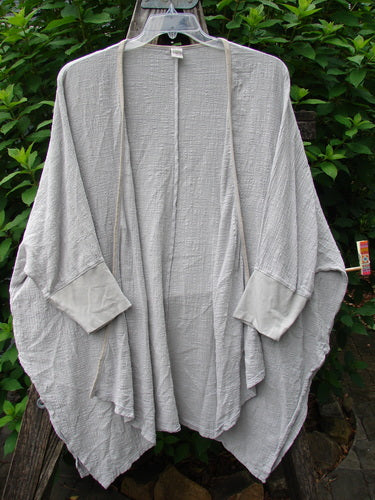 Barclay Gauze Open Front Cardigan Unpainted Natural Size 2 displayed, featuring dolman sleeves, open front, varying hemline, vented sides, contrasting cuffs, and a generous, boxy silhouette ideal for creative expression.