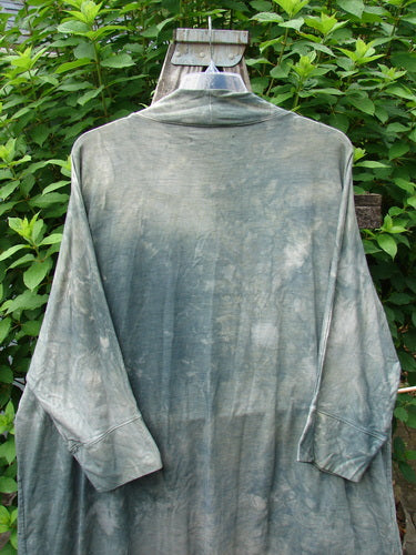 Barclay Bamboo Dolman Day Jacket in Mottled Field Grass displayed on a wall, featuring an open front, two drop pockets, dolman sleeves, and a unique hemline, embodying Bluefishfinder.com's vintage aesthetic.