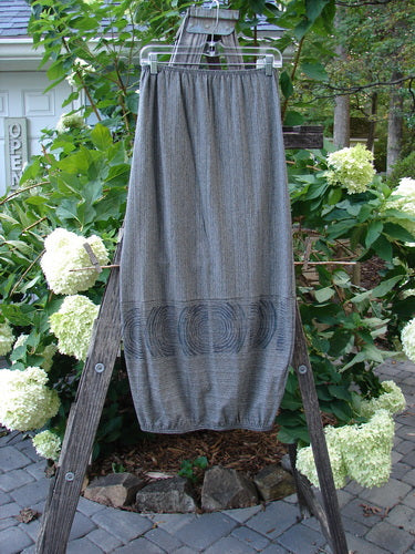 2000 Rayon Lycra Promenade Skirt Celtic Stripe Cliffshadow Size 0 displayed draped over a wooden ladder, showcasing its full elastic waistband and horizontal accent seams.