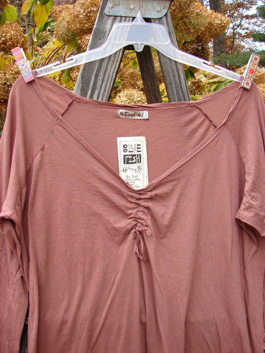 Barclay NWT Batiste Decora Ragtime Raglan Heirloom Size 2 ai: A pink shirt with unique front drawcord accent, pleats on shoulder diagonals, and a slight figure 8 shape.