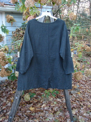 Barclay Woven Summercloth Figure 8 Pocket Tunic Dress Unpainted Forest Size 2 displayed on a clothes rack, showcasing its heavy-weight, long-sleeved design, ideal for expressing individual style.