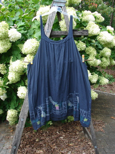 Barclay Batiste Banded Collar Slip Dress Birdy Border in black, size 2, hangs from a wooden ladder with a softly gathered bodice and thin shoulder straps. The lightweight batiste fabric falls in a loose A-line shape, finished with a subtle birdy border print near the hem.